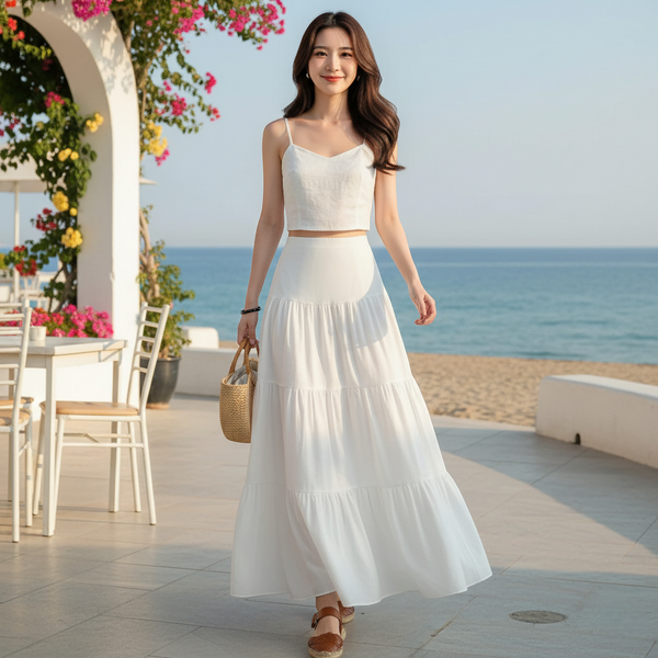 Jupe longue blanche fluide en coton léger, coupe évasée avec volants, idéale pour l'été. Image
